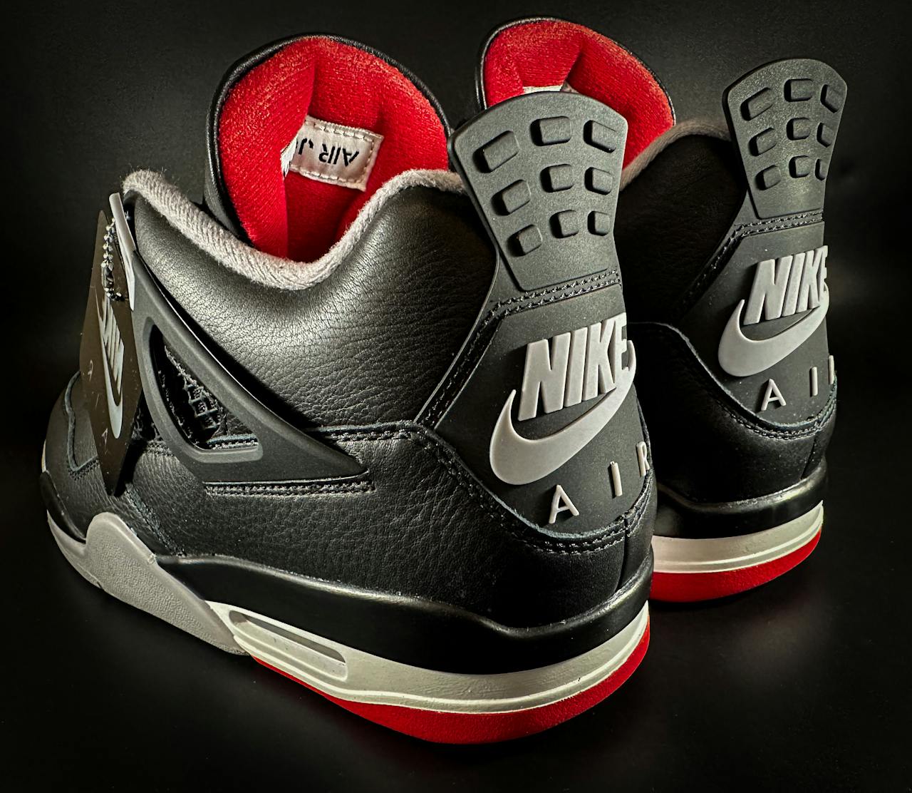 why-choose-us Detailed image of black and red Nike high-top sneakers showcasing iconic branding and design.